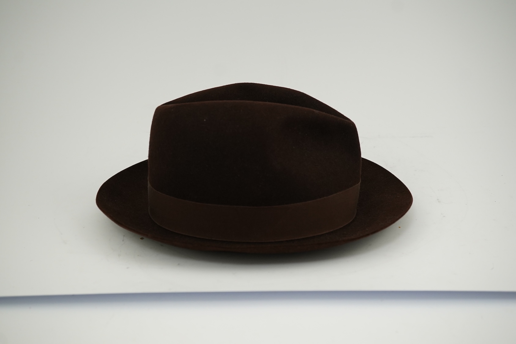 A brown felt Dunn and Co hat Size 56